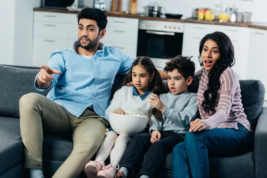 Happy family enjoying Thunder TV subscription with streaming plans for ultimate family entertainment